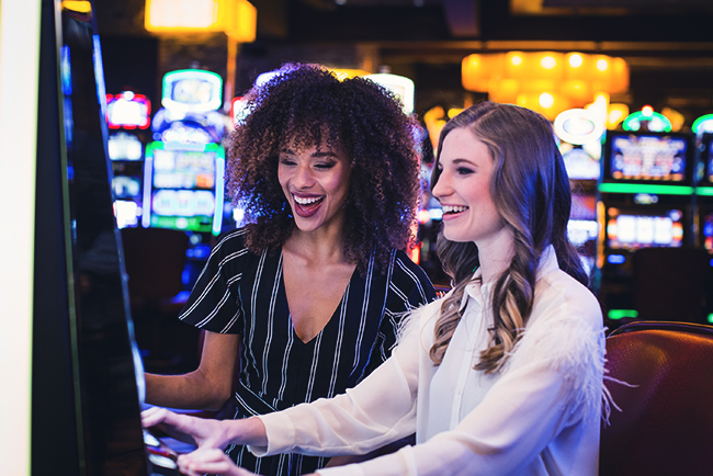 Two women playing slots