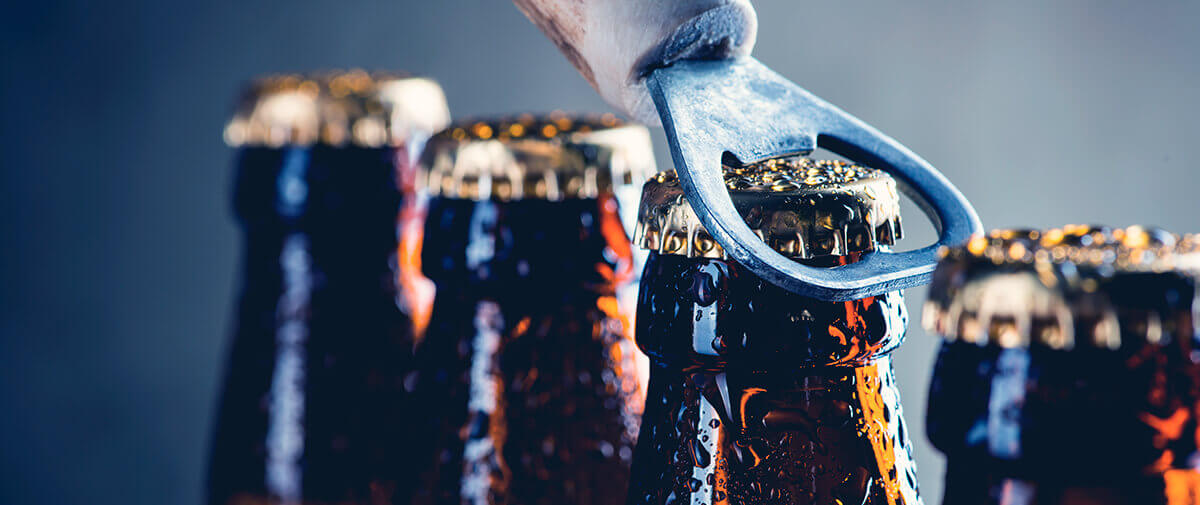 Bottle opener opening a chilled drink