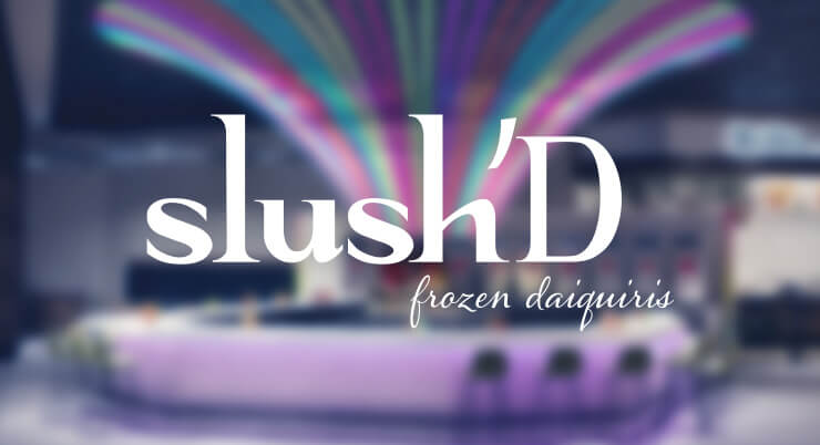 slush’D—frozen daiquiris—logo over a blurred view of the bar