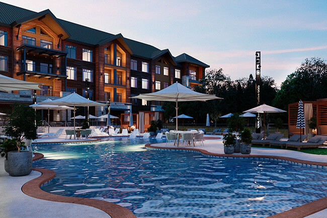 Lodge-style resort pool at Choctaw Landing at dusk with umbrellas, in-water loungers, and cabanas.